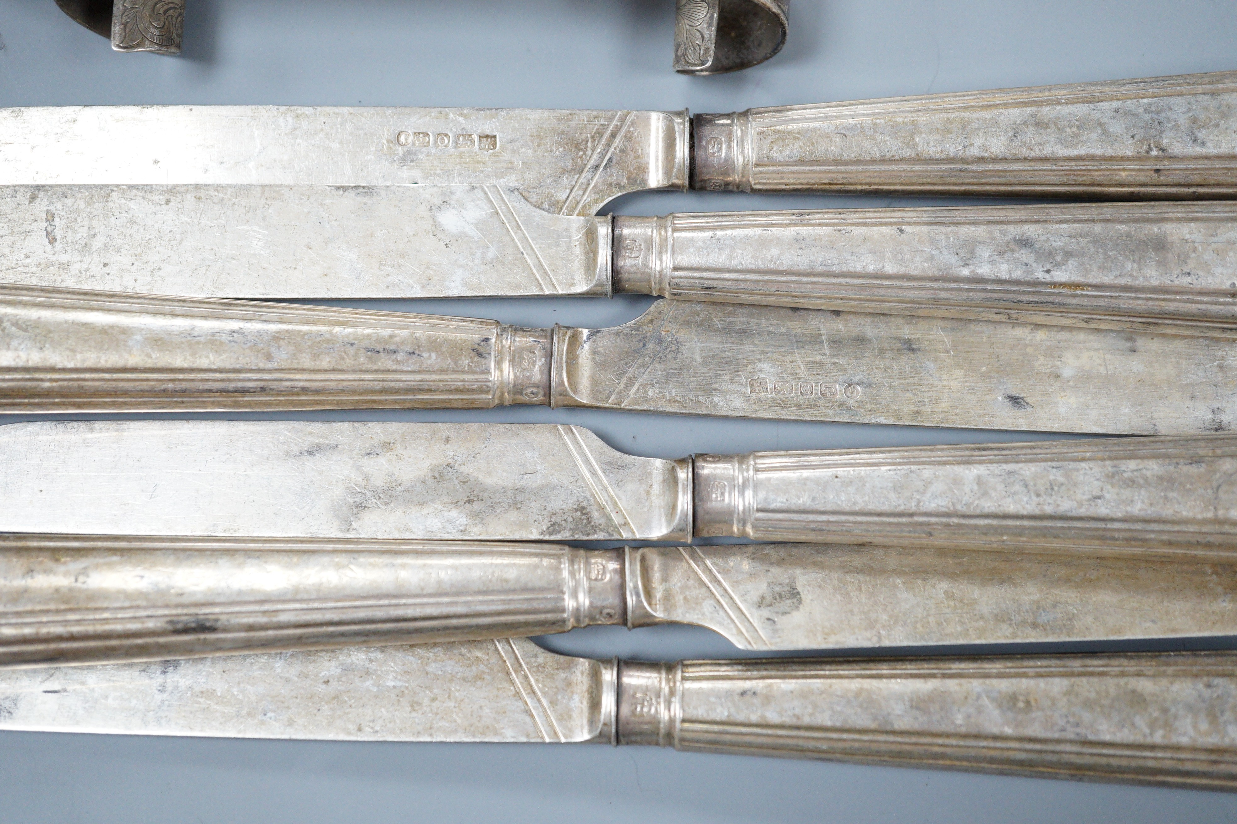 A pair of Victorian silver scrolling knife rests, George Adams, London, 1859, 10.4cm, a pair of pierced silver spoons, two pairs of silver sugar tongs, a part set of Victorian silver dessert eaters(6 & 5), a toddy ladle